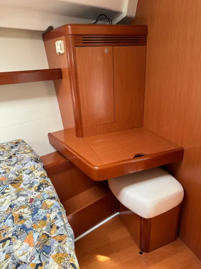 Deep Unreal Yacht Photos Pics Cozy cabin interior of 2008 Beneteau Oceanis 40 with wooden desk and patterned bedding.