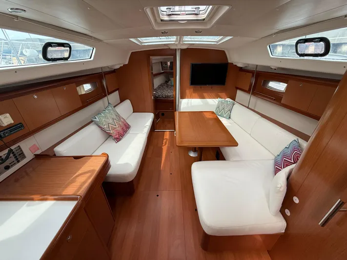 Deep Unreal Yacht Photos Pics Interior of 2008 Beneteau Oceanis 40 yacht with wood finish and white seating.
