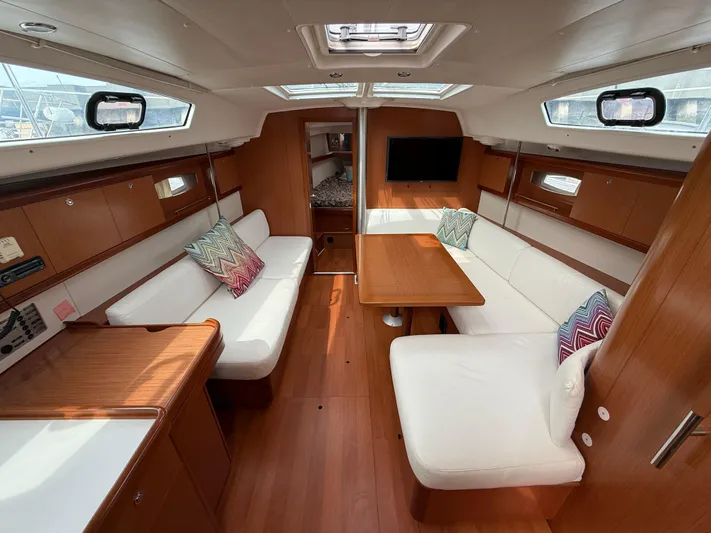 Deep Unreal Yacht Photos Pics Interior of 2008 Beneteau Oceanis 40 yacht with wood finish and white seating.