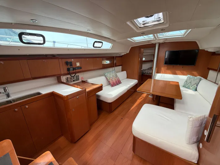 Deep Unreal Yacht Photos Pics Interior of 2008 Beneteau Oceanis 40 yacht with wood finish and white seating.