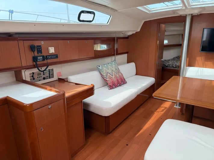 Deep Unreal Yacht Photos Pics Interior of 2008 Beneteau Oceanis 40 yacht with wood finish and white seating.