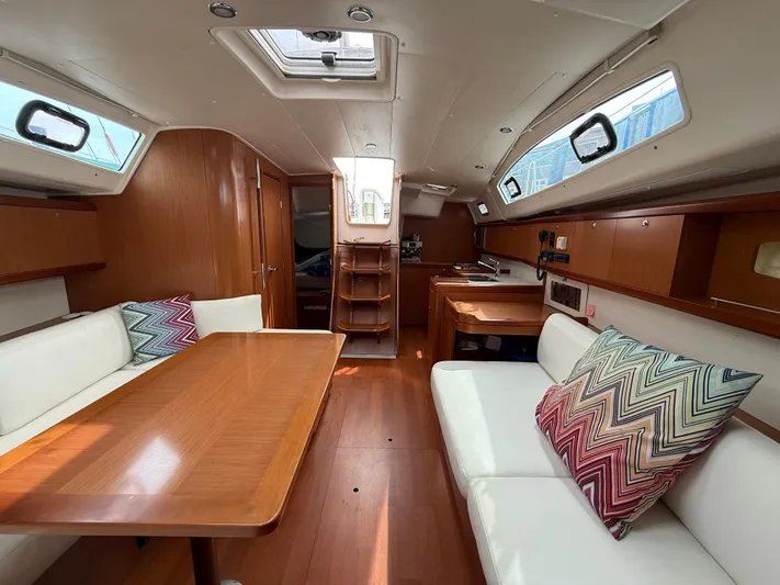 Deep Unreal Yacht Photos Pics Interior of 2008 Beneteau Oceanis 40 yacht with wood finish and colorful cushions.