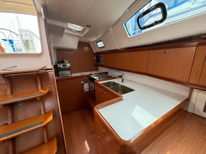 Deep Unreal Yacht Photos Pics Interior of 2008 Beneteau Oceanis 40 yacht kitchen with wood cabinetry and modern appliances.