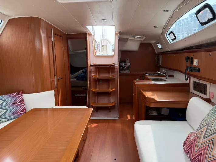 Deep Unreal Yacht Photos Pics Interior of 2008 Beneteau Oceanis 40 sailboat with wood finish and cozy seating area.
