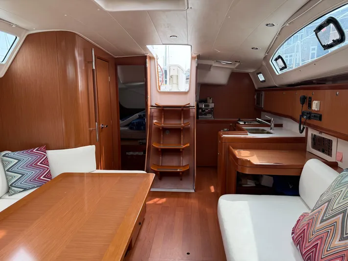 Deep Unreal Yacht Photos Pics Interior of 2008 Beneteau Oceanis 40 sailboat, featuring wood finish and cozy seating area.