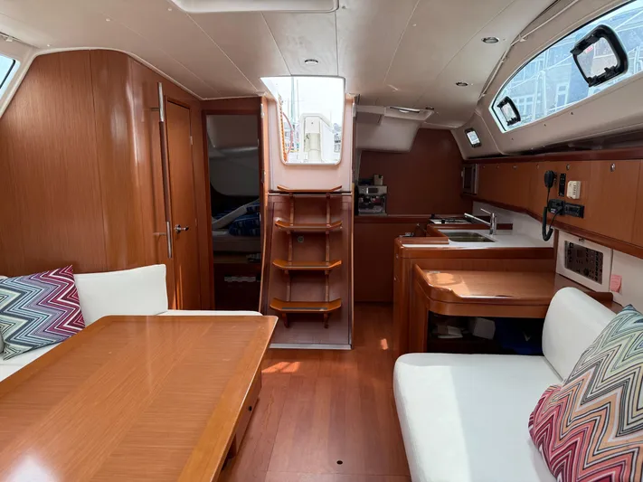 Deep Unreal Yacht Photos Pics Interior of 2008 Beneteau Oceanis 40 sailboat with wood finish and cozy seating area.