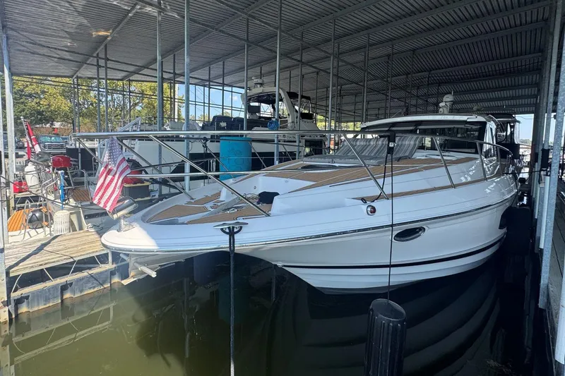  Yacht Photos Pics 2016 Regal 46 Sport Coupe docked in a covered marina, featuring sleek design and American flag.