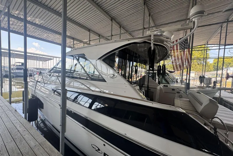  Yacht Photos Pics 2016 Regal 46 Sport Coupe yacht docked in a marina under a covered structure.