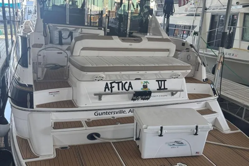  Yacht Photos Pics 2016 Regal 46 Sport Coupe yacht docked, featuring spacious deck and seating area.