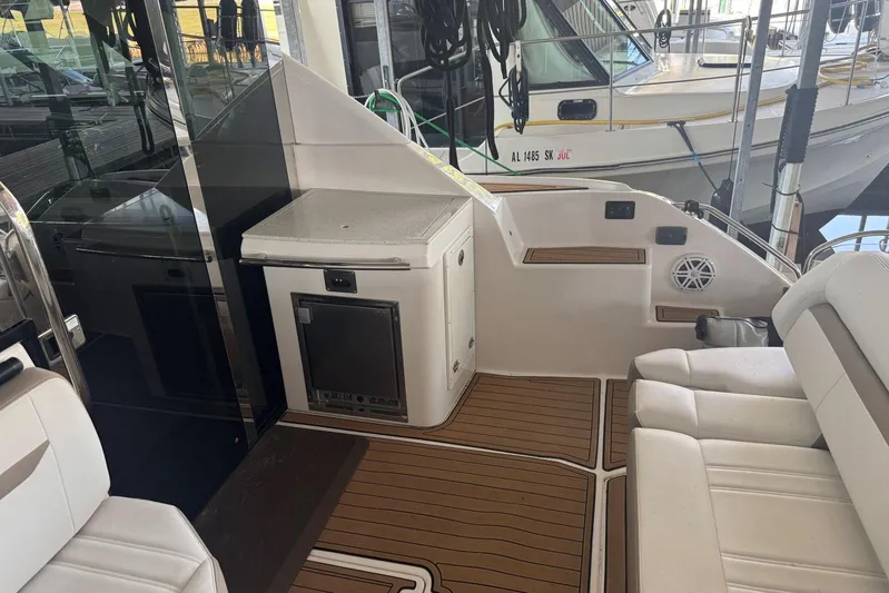  Yacht Photos Pics 2016 Regal 46 Sport Coupe interior with seating and kitchenette on teak flooring.