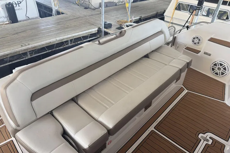  Yacht Photos Pics Luxurious seating on 2016 Regal 46 Sport Coupe yacht, featuring elegant beige upholstery.