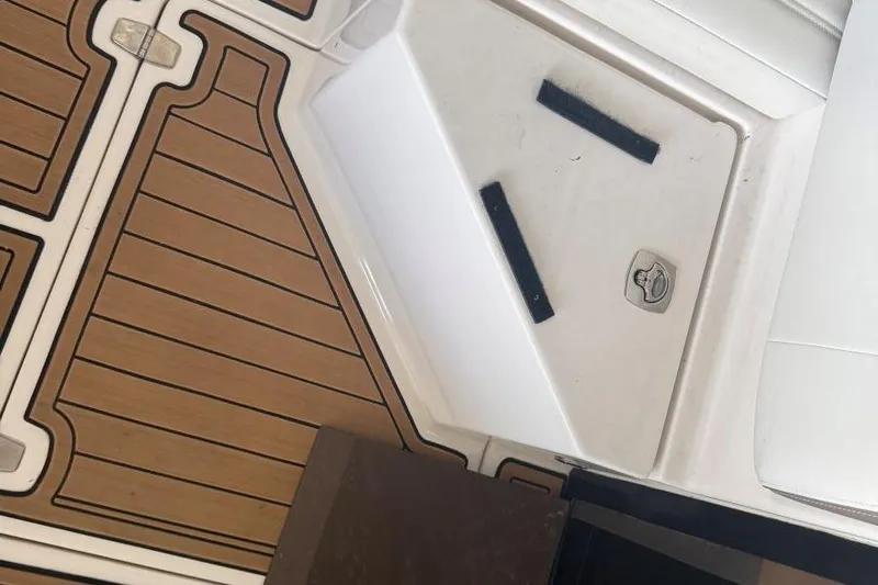  Yacht Photos Pics 2016 Regal 46 Sport Coupe deck with wood finish and storage compartment.