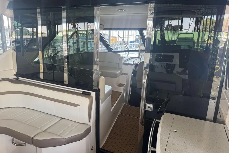  Yacht Photos Pics Interior view of 2016 Regal 46 Sport Coupe yacht with seating and glass doors.