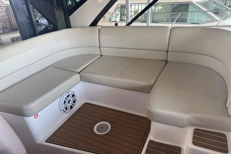  Yacht Photos Pics Luxurious seating area on a 2016 Regal 46 Sport Coupe yacht, featuring beige cushions.