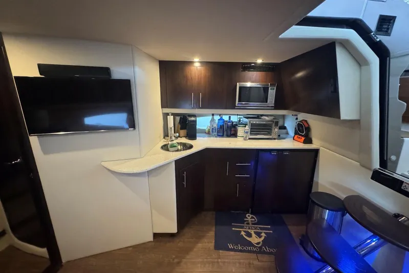  Yacht Photos Pics Interior of 2016 Regal 46 Sport Coupe yacht with kitchenette and modern amenities.