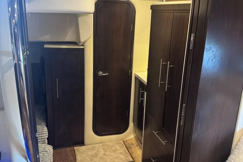  Yacht Photos Pics Interior of 2016 Regal 46 Sport Coupe with dark wood cabinetry and door.