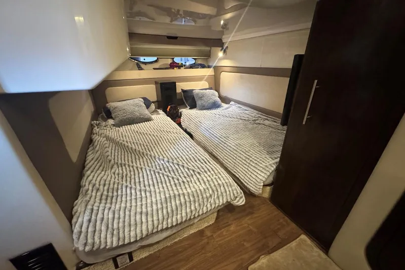  Yacht Photos Pics Interior cabin of 2016 Regal 46 Sport Coupe with twin beds and modern decor.