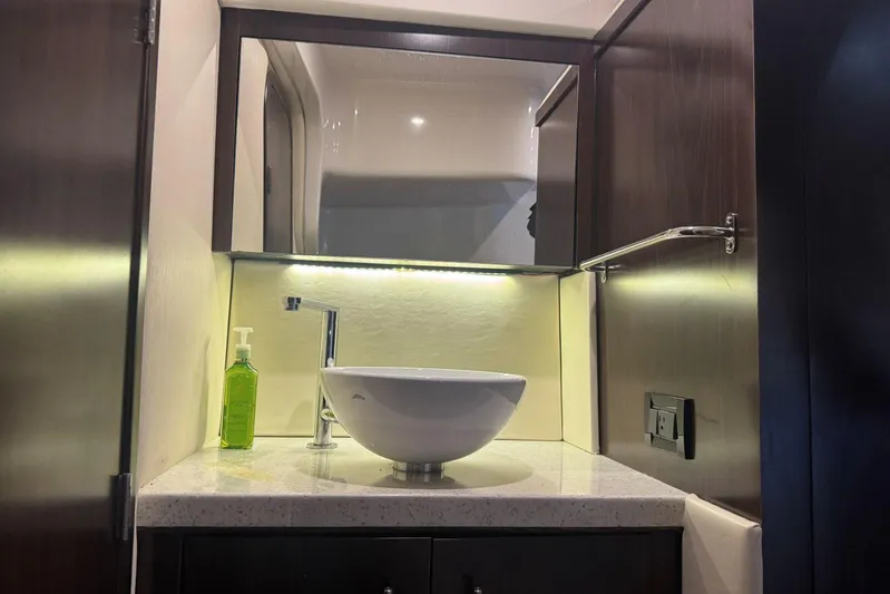  Yacht Photos Pics Modern bathroom vanity in 2016 Regal 46 Sport Coupe yacht, featuring vessel sink and mirror.