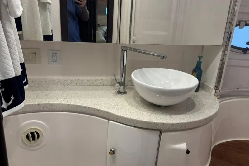  Yacht Photos Pics Modern bathroom vanity in 2016 Regal 46 Sport Coupe yacht, featuring vessel sink and sleek faucet.