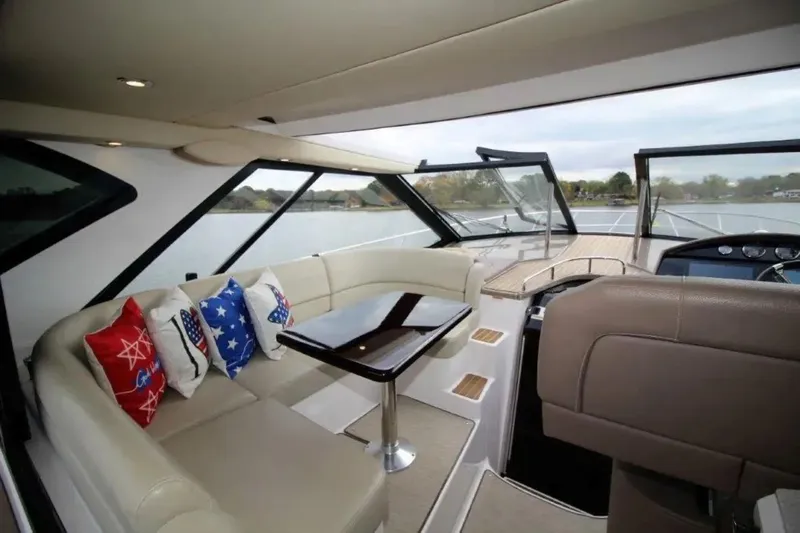  Yacht Photos Pics Interior of 2016 Regal 46 Sport Coupe yacht with seating and decorative pillows.