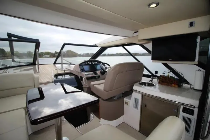  Yacht Photos Pics Luxurious interior of 2016 Regal 46 Sport Coupe yacht with helm, seating, and kitchenette.