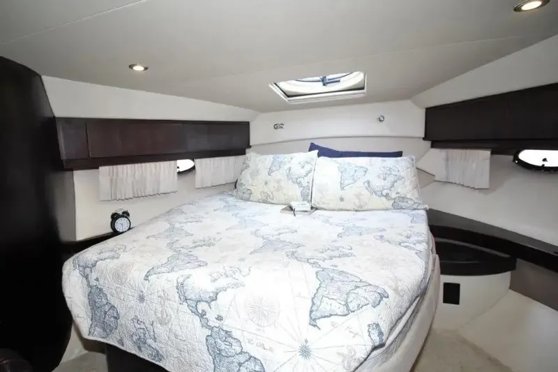  Yacht Photos Pics Luxurious bedroom interior of 2016 Regal 46 Sport Coupe yacht with map-themed bedding.