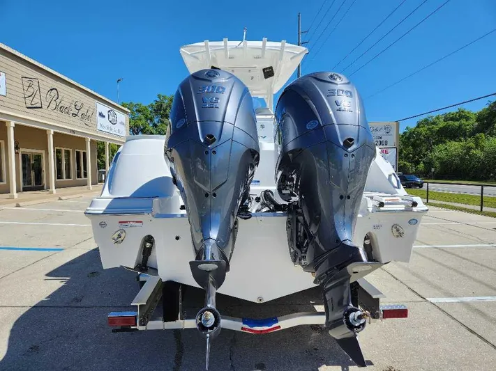 Black Label Marine Yacht Photos Pics 2023 Sea Fox 288 Commander with dual outboard engines, parked outdoors.