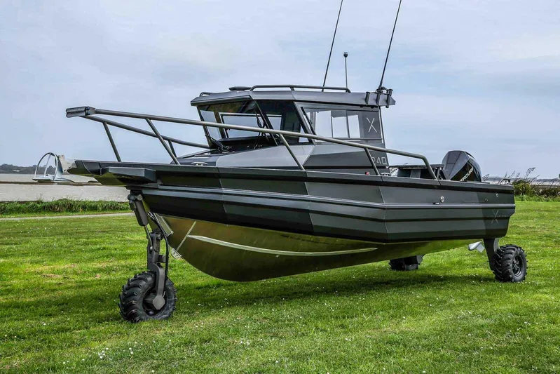  Yacht Photos Pics 2024 StabiX 240UCC amphibious boat on grassy terrain, showcasing rugged design and versatility.