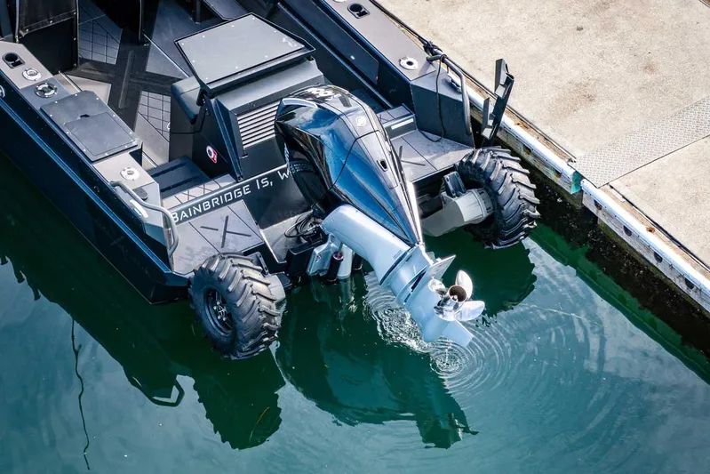  Yacht Photos Pics Amphibious vehicle StabiX 240UCC 2024 with outboard motor docked at a pier.