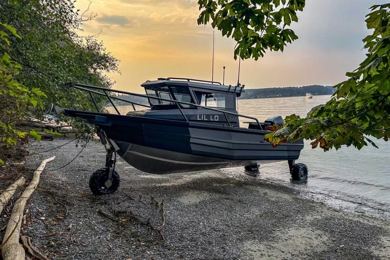  Yacht Photos Pics StabiX 240UCC 2024 amphibious boat on a pebbled beach at sunset.