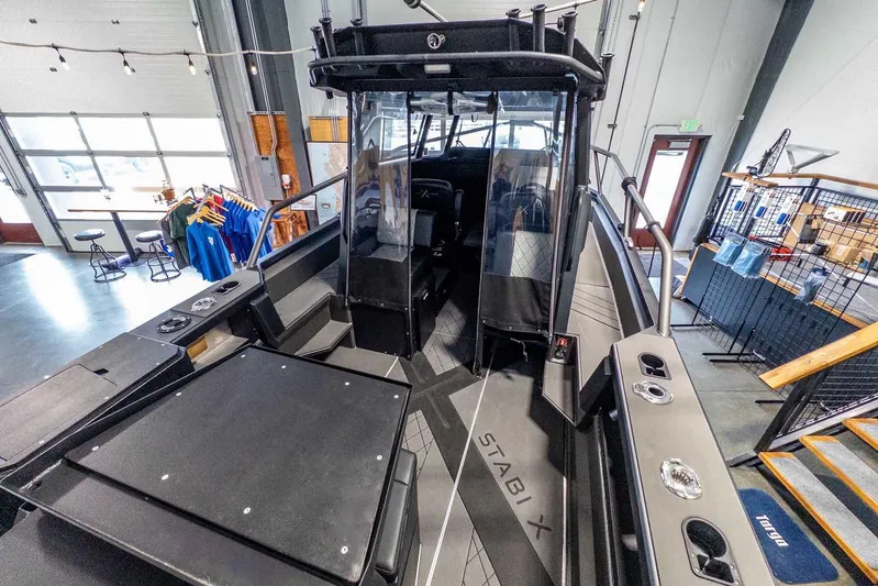  Yacht Photos Pics 2024 StabiX 240UCC boat interior in showroom, featuring sleek design and modern amenities.