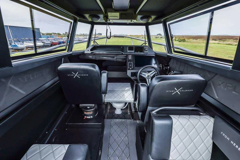  Yacht Photos Pics Interior of 2024 StabiX 240UCC boat with modern seating and control panel.