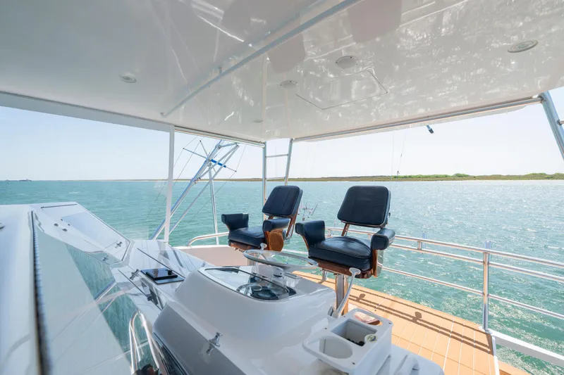 Walk West Yacht Photos Pics 2001 Viking Convertible yacht helm with ocean view and comfortable seating.