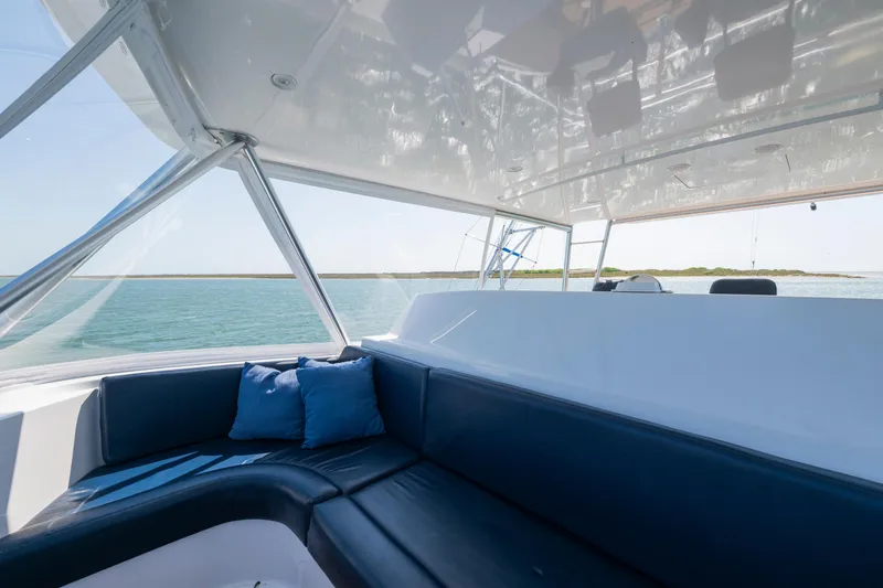 Walk West Yacht Photos Pics Interior of 2001 Viking Convertible yacht with blue seating and ocean view.