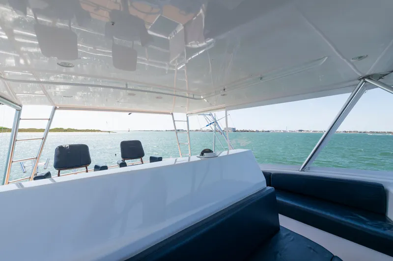 Walk West Yacht Photos Pics 2001 Viking Convertible yacht interior with ocean view and seating area.