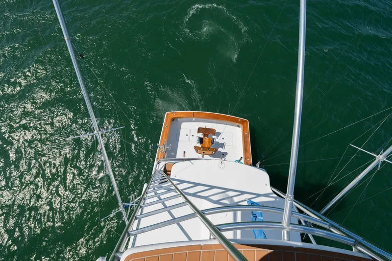 Walk West Yacht Photos Pics Aerial view of 2001 Viking Convertible yacht on green ocean water.