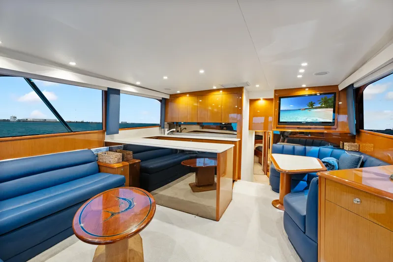 Walk West Yacht Photos Pics Luxurious interior of a 2001 Viking Convertible yacht with elegant wood finishes and blue seating.