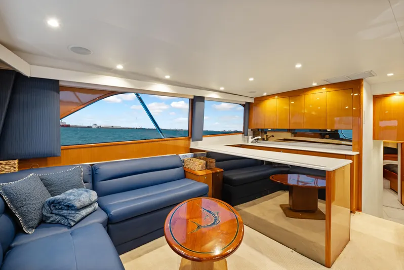 Walk West Yacht Photos Pics Luxurious interior of a 2001 Viking Convertible yacht with blue seating and wooden accents.