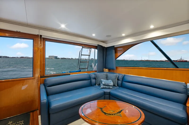 Walk West Yacht Photos Pics Luxurious interior of a 2001 Viking Convertible yacht with blue seating and ocean view.
