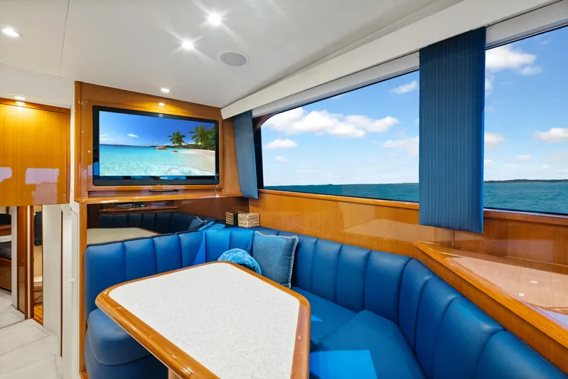 Walk West Yacht Photos Pics Luxurious interior of a 2001 Viking Convertible yacht with ocean view and blue seating.