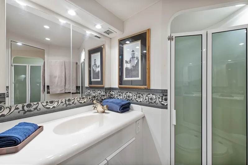 Walk West Yacht Photos Pics Luxurious bathroom in 2001 Viking Convertible yacht with elegant decor and modern fixtures.