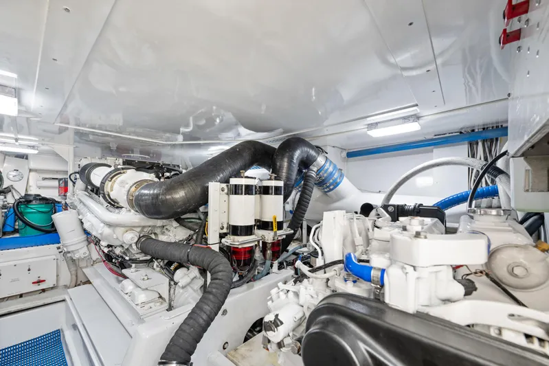 Walk West Yacht Photos Pics Engine room of a 2001 Viking Convertible yacht, showcasing complex machinery and piping.