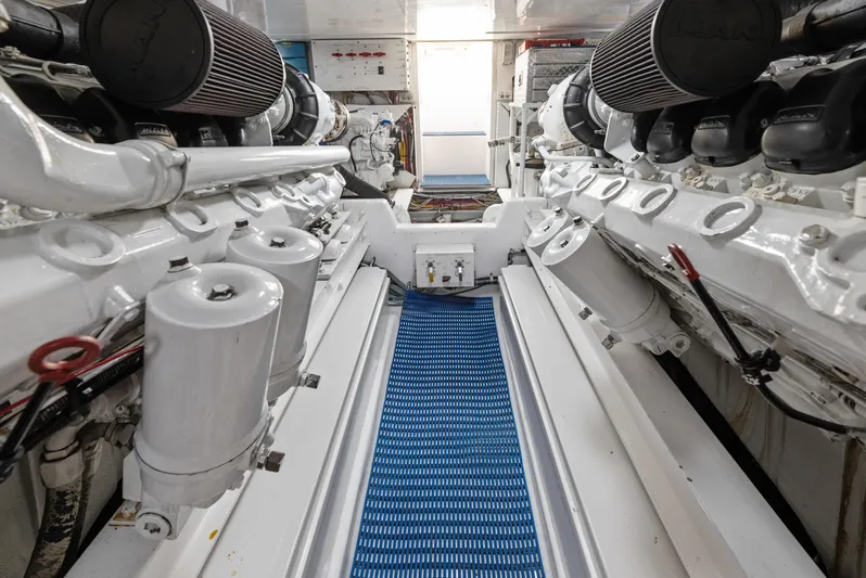 Walk West Yacht Photos Pics Engine room of a 2001 Viking Convertible yacht, showcasing dual engines and clean layout.