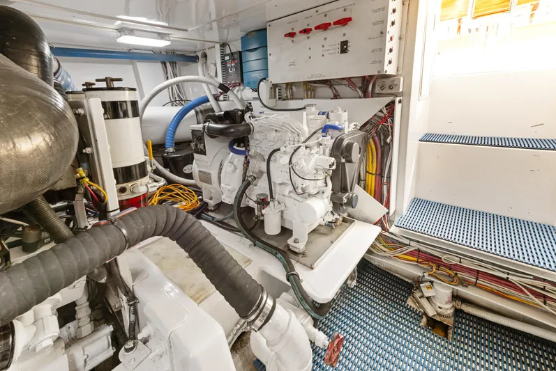 Walk West Yacht Photos Pics Engine room of a 2001 Viking Convertible boat, featuring complex machinery and wiring.