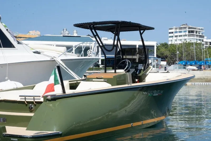  Yacht Photos Pics 2026 Lilybaeum Levanzo 25 Lounge Deck boat docked in marina, Italian flag displayed.