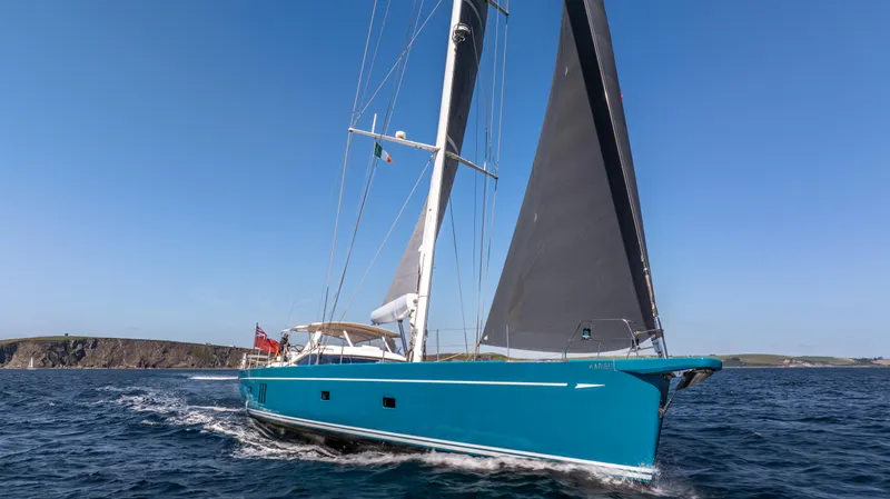 Karibu Yacht Photos Pics Sailing yacht Oyster 885, 2013 model, cruising on open sea under clear blue sky.