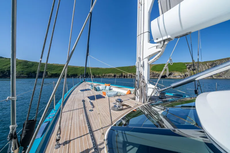 Karibu Yacht Photos Pics Luxurious 2013 Oyster 885 yacht deck with scenic coastal view and clear blue sky.