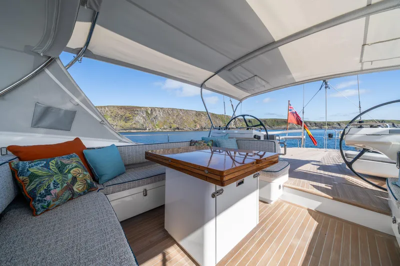 Karibu Yacht Photos Pics Luxurious 2013 Oyster 885 yacht deck with seating, table, and scenic ocean view.