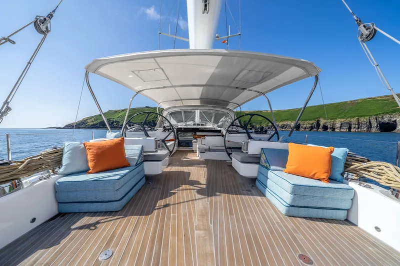 Karibu Yacht Photos Pics Luxurious 2013 Oyster 885 yacht deck with plush seating, ocean view, and clear blue sky.