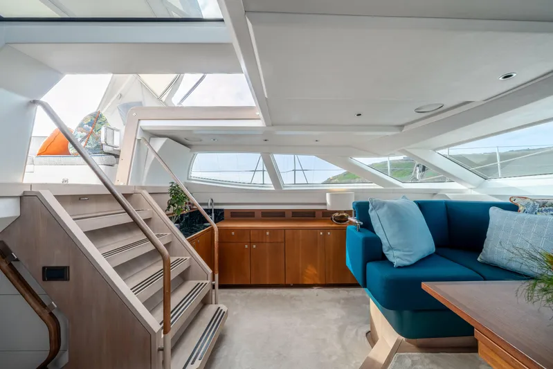 Karibu Yacht Photos Pics Luxurious interior of 2013 Oyster 885 yacht with modern seating and wooden cabinetry.